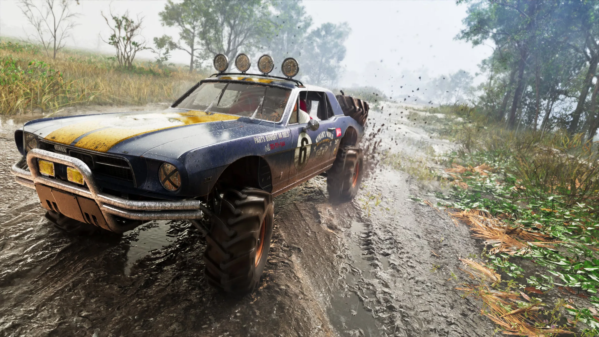 A muddy off-road muscle car tearing through a forest trail